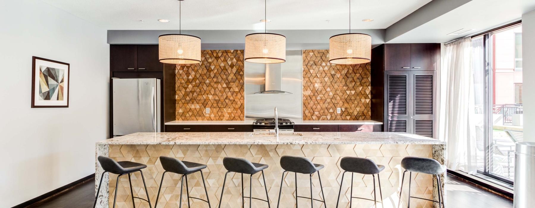 Modern chef's kitchen with kitchen island at Velo's studio, 1, and 2-bedroom apartments in Minneapolis