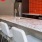 a kitchen with white chairs