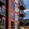 a building with balconies and a grass lawn