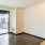 a room with a glass door and a wood floor