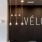 a room with a couch and a table with a sign above it